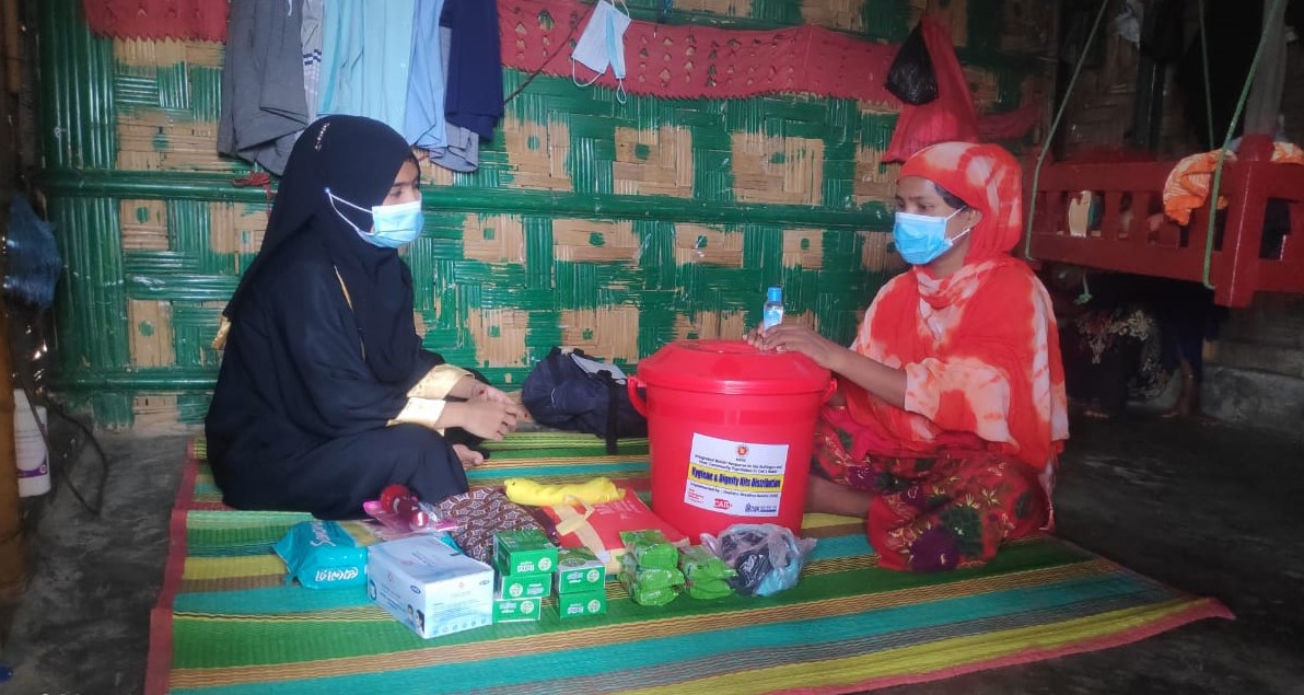 A Rohingya refugee woman receives a covid-care kit in camp 15, Cox’s Bazar